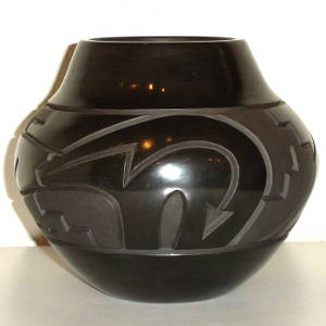 Bear, kiva step and geometric design carved into a polished black jar