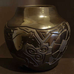 Geometric designs carved into a black on black jar 