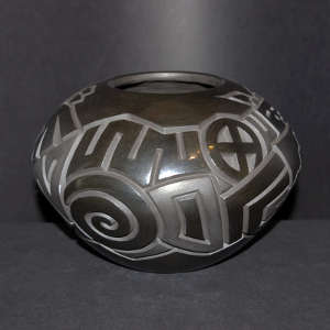 Dancers, Tularosa spirals and geometric design carved into a black on black jar
