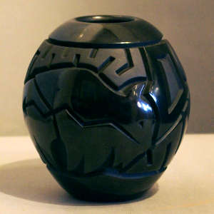 Buffalo, storm cloud and geometric design carved into a black jar