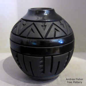 Geometric design carved into a black on black jar