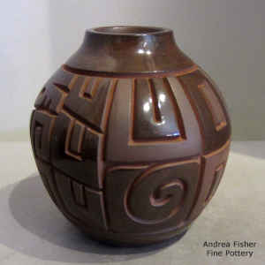 Geometric design carved into a brown on brown jar