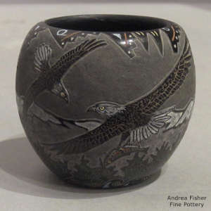 Sgraffito eagle and geometric design on a black jar