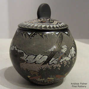 Sgraffito wildlife scene on a lidded black jar