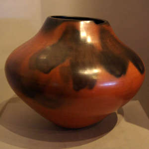 Fire clouds on a polished red jar