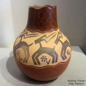 Sgraffito animal and flower design on a sienna jar