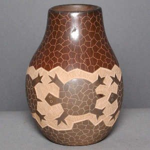 Sgraffito turtle design on a brown jar