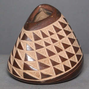 Sgraffito geometric design on a brown jar with triangular opening