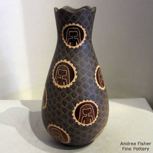 Sienna spots and sgraffito medallion design on a brown jar