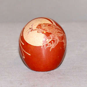 Sgraffito frog catching a mosquito design on a red seed pot