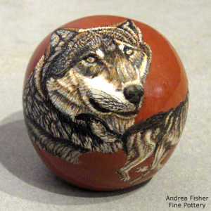 Sgraffito and painted wolf and geometric design on a polychrome seed pot