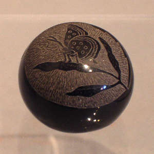 Sgraffito butterfly design on a black seedpot