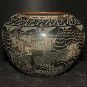 Sgraffito nature, wildlife and geometric designs on a black jar with a sienna rim