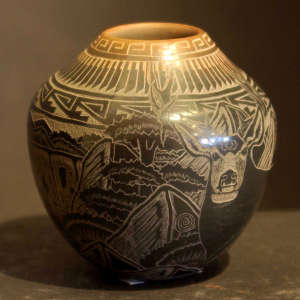 Sgraffito feather, nature and geometric designs on a black jar with a sienna rim