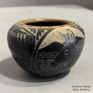 Sgraffito pueblo, wildlife, feather, avanyu and geometric design on a black  jar with a sienna rim