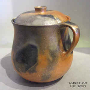 Fire clouds decorate a golden micaceous lidded pitcher