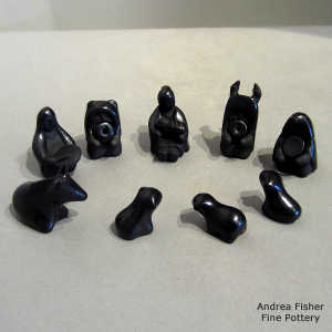 13 pieces in a black on black miniature nativity set