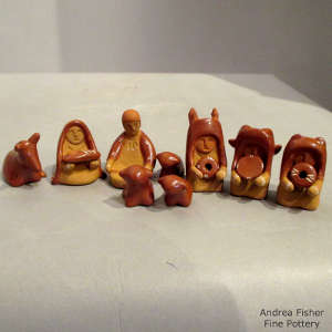 Click to see a larger version Thirteen pieces in a miniature red nativity set