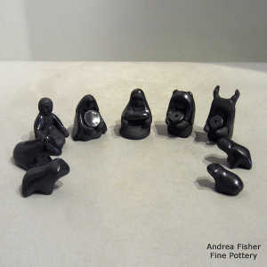 13 pieces in a black on black nativity set
