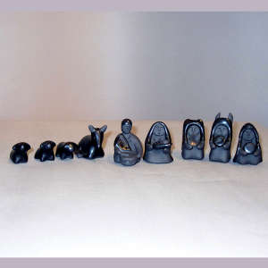 13 pieces in a black on black miniature Nativity set