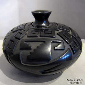 Black jar carved with a kiva step, avanyu and geometric design