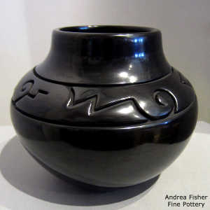 Geometric design carved into a black jar