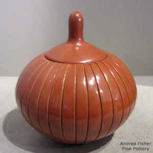 Lidded red jar carved with a melon design