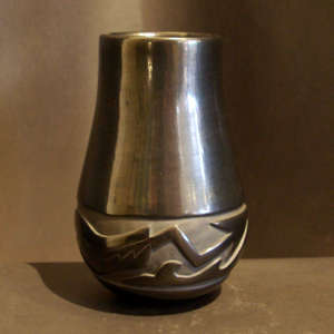 Avanyu design carved into a tall black jar