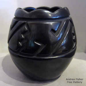 Geometric design carved into a black jar