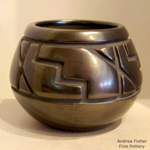 Kiva step and geometric design carved into a black jar