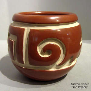 Geometric design carved into a red jar