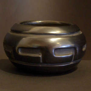 Geometric design carved into a black jar