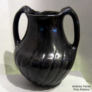 Swirl melon base on a black water jar with handles