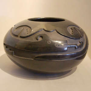 Avanyu and geometric design carved into a black jar