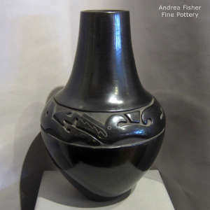 Avanyu design carved into a tall black jar