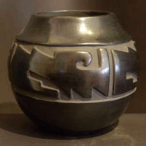 Geometric design carved into a polished black jar