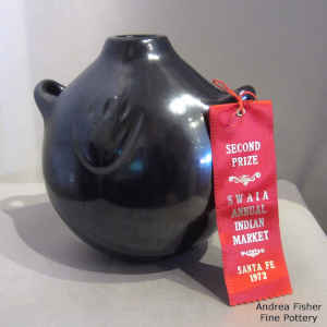 Black canteen with bear paw imprint