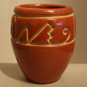 Geometric design carved into a red jar