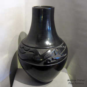 Anavanyu design carved into a large black jar