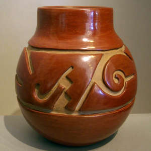Geometric design carved into a deep red jar