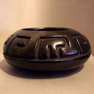 An interlocking key design carbed into a black jar