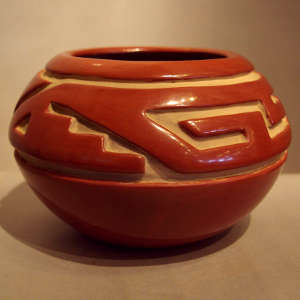 Geometric design carved into a red jar