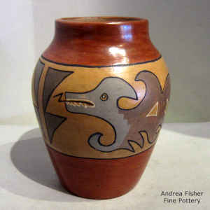 An avanyu and geometric design painted on a polychome jar