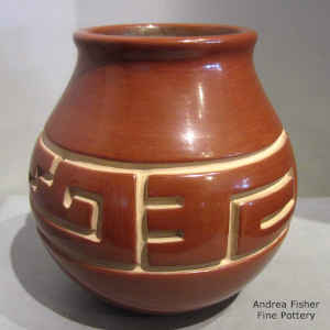 Geometric design carved into a red jar