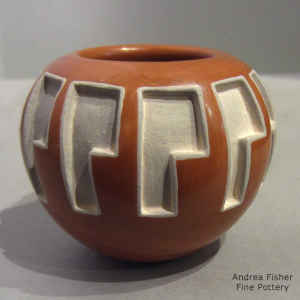 A geometric design carved into a red jar