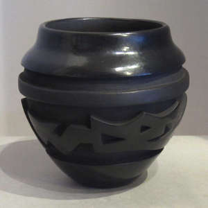 Avanyu design carved into a black jar