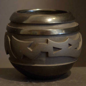 Avanyu design carved in to a black on black jar