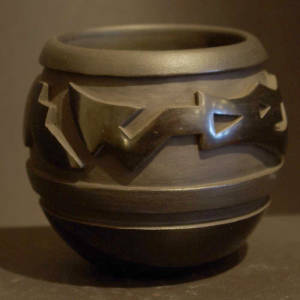 Avanyu design carved into a black on black jar