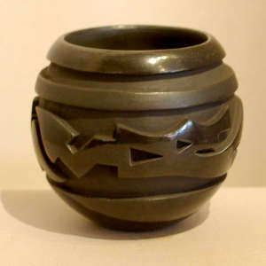 Avanyu design carved into a black jar