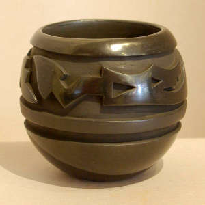 Avanyu design carved into a black on black jar